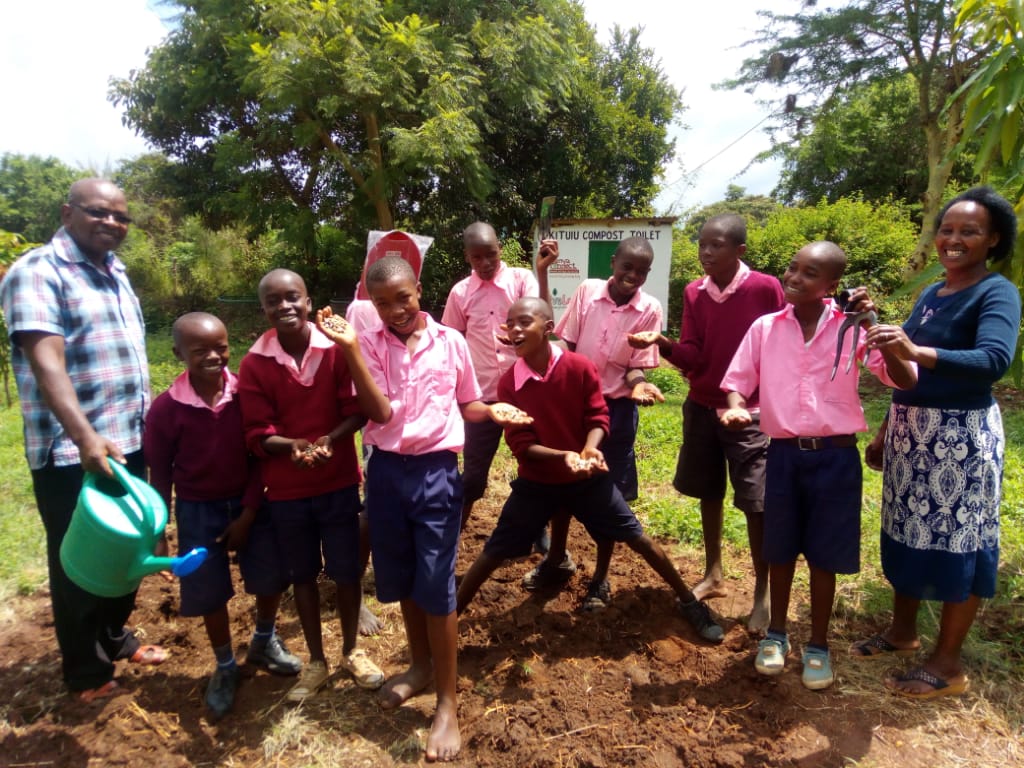Students at Kitui Primary School, Kenya, planting moringa trees as part of the School Enterprise Challenge.